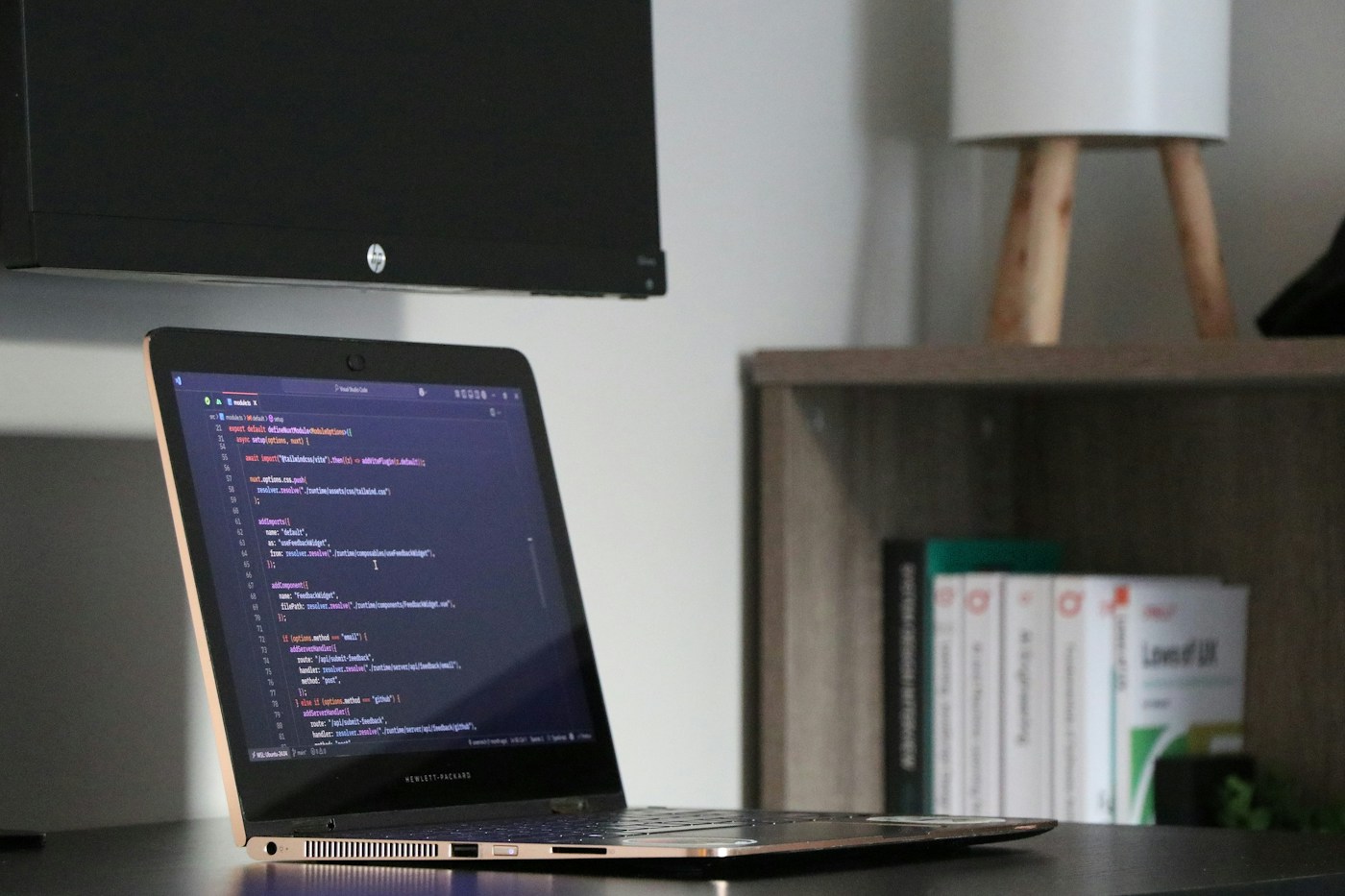 Laptop displaying code in a developer workspace